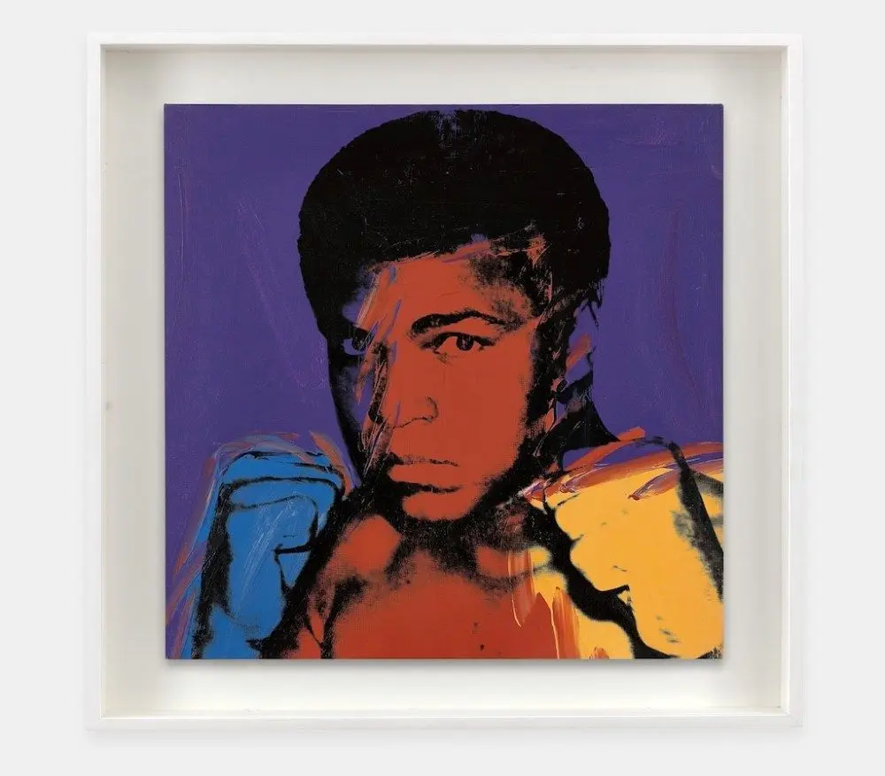 A painting of Muhammad Ali looking at the viewer, surrounded by a purple background.