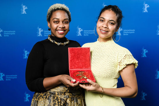 Producer+Monica+Sorelle+(L)+and+screenwriter+Keisha+Rae+Witherspoon+pose+with+the+Golden+Bear+for+Best+Short+Film+award+for+the+film+T