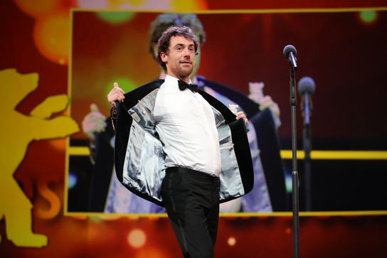 Elio+Germano_+winner+of+the+Silver+Bear+for+Best+Actor+for+the+film+Hidden+Away+is+seen+on+stage+at+the+closing+ceremony+of+the+70th+Berlinale+International+Film+Fe