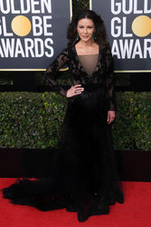 Catherine Zeta-Jones takes the ‘black with sheer panels and colourful earrings’ route at the Golden Globes.